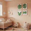 Modern Nursery Room with Tropical Leaf Wall Art and Soft Pink Decor