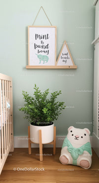 Cozy Baby Room with Plush Teddy Bear and Green Plant Decor