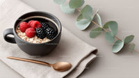 Fresh Berry Breakfast in Black Mug with Oatmeal and Greenery