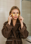Woman Applying Under-Eye Patches for Skincare Wellness