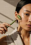 Close-up of a woman using a jade roller on her face for skincare