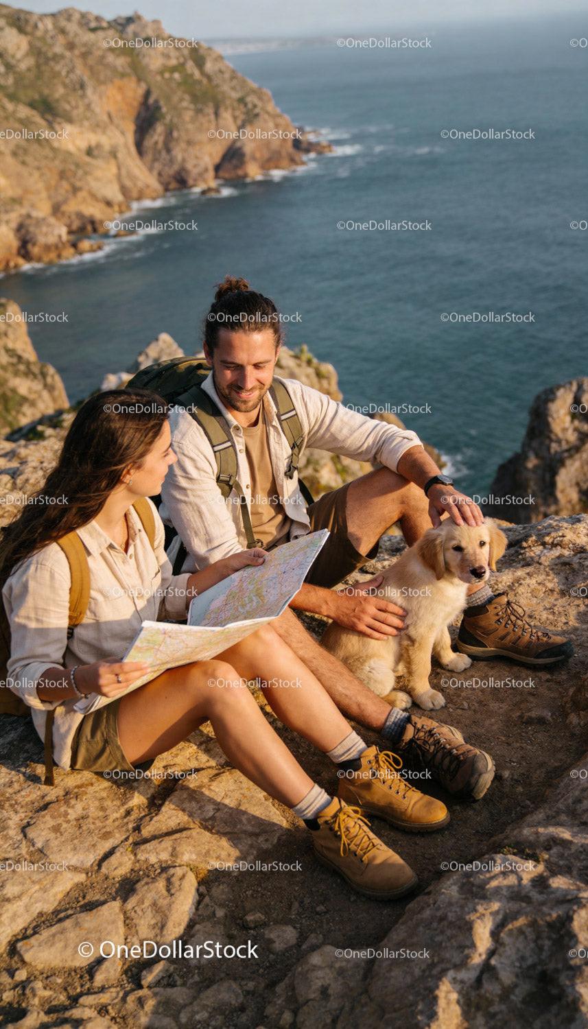 Couple Exploring Coastal Cliffs with Golden Retriever Puppy