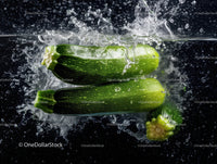 Fresh Green Zucchini Vegetables Floating in Water with Splash Effect