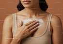 Close-up of a Woman Applying Skincare Cream to Chest for Healthy Skin