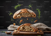 Rustic sourdough bread sliced with fresh rosemary herb