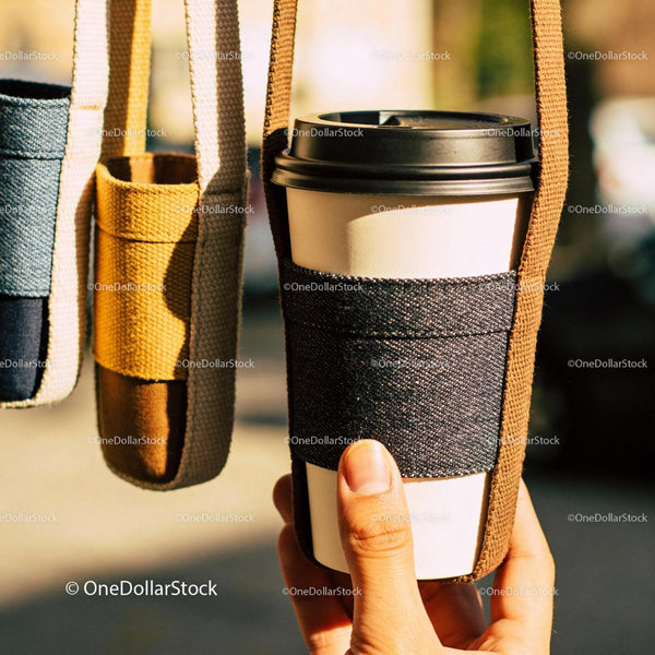Hand Holding Coffee Cup in Fabric Carrier Outdoors