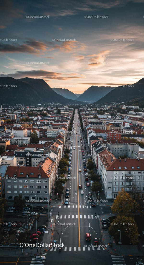 Scenic Mountain Town at Sunset with Urban Street and Mountain Range