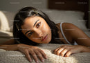 Portrait of Young Woman Lying on Beige Carpet with Natural Light