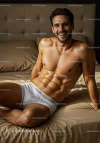 Smiling muscular man relaxing on beige bed in white underwear