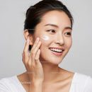 Young Woman Applying Skincare Cream for Radiant Skin