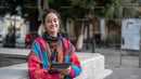 Colorful Woman Smiling with Tablet in City Park