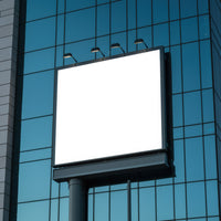 Empty illuminated billboard on modern office building facade