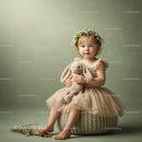 Toddler girl in floral crown holding stuffed bunny