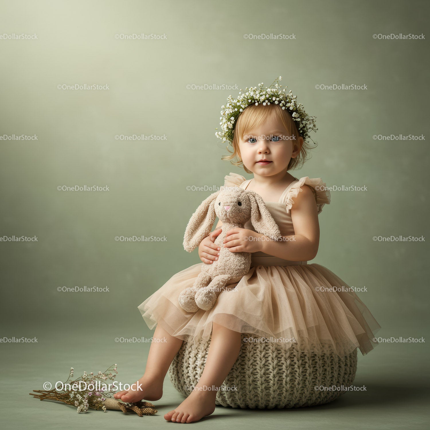Toddler girl in floral crown holding stuffed bunny