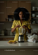 Woman Preparing Banana Smoothie in Modern Kitchen