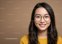 Smiling Woman with Glasses in Studio Portrait Wearing Yellow Sweater
