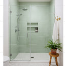 Modern green tiled shower with glass door and wooden stool