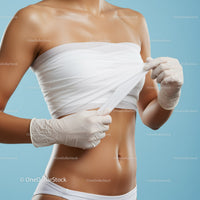 Woman Removing Bandage from Her Bare Shoulder and Arm