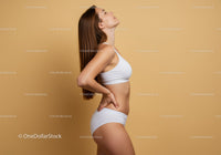 Fitness Model in White Sportswear Posing Confidently Against Yellow Background