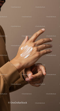 Close-up of Person Applying Lotion on Hand for Skincare Routine