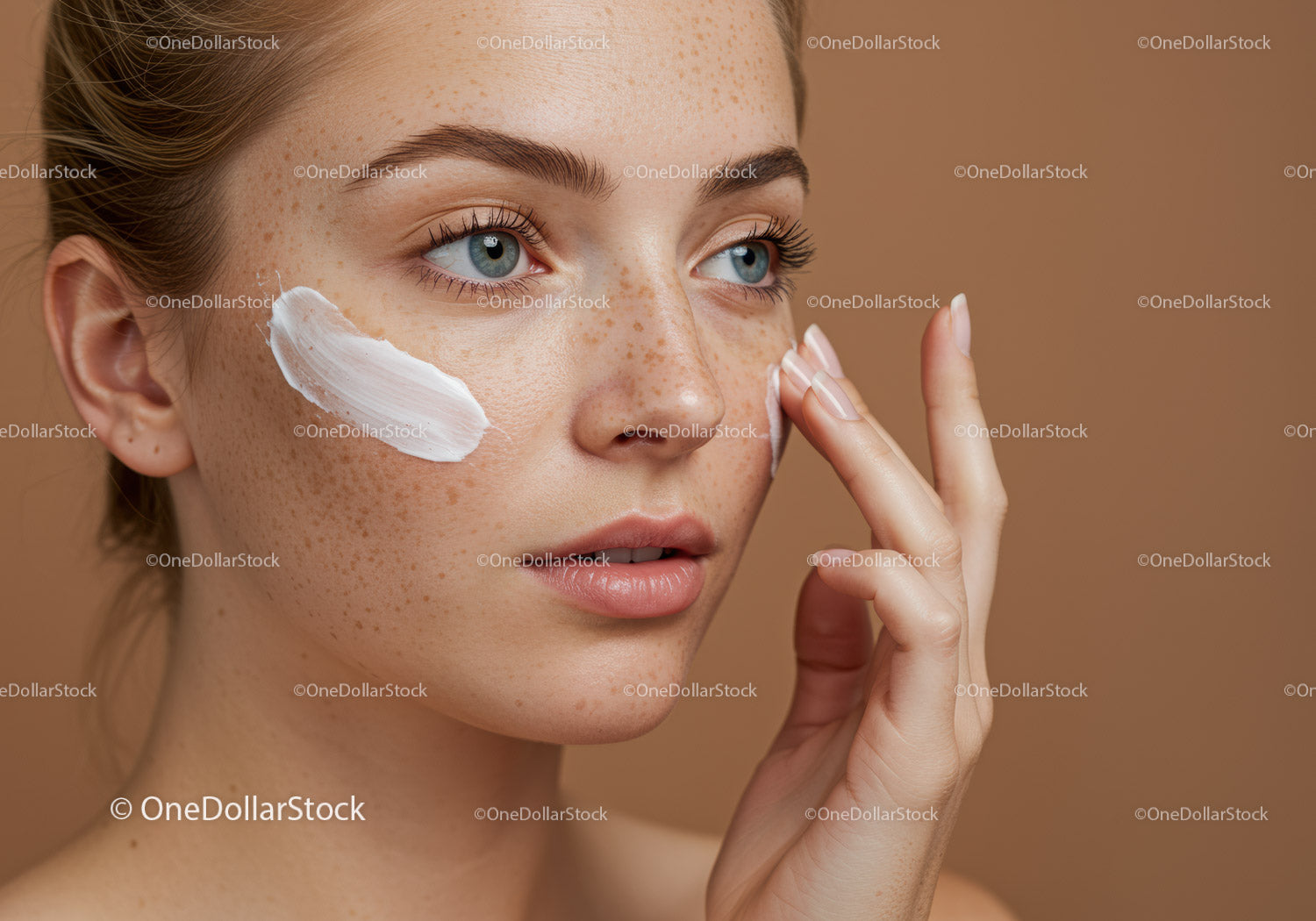 Close-Up of Young Woman Applying Face Cream for Healthy Glowing Skin