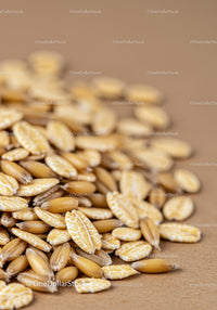 Close up of rye and oat grains on rustic surface