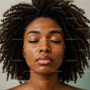 Elegant Woman with Curly Hair Relaxing During Facial Skincare Routine