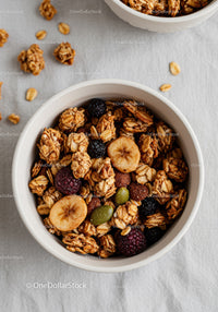 Close-up of granola with dried banana and berries in bowl