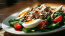 Healthy Tuna Salad with Cherry Tomatoes and Eggs in Fresh Green Spinach