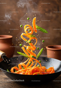 Fresh carrot ribbons stir-fried with green peas in wok