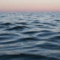 Calm Ocean with Gentle Waves at Sunset