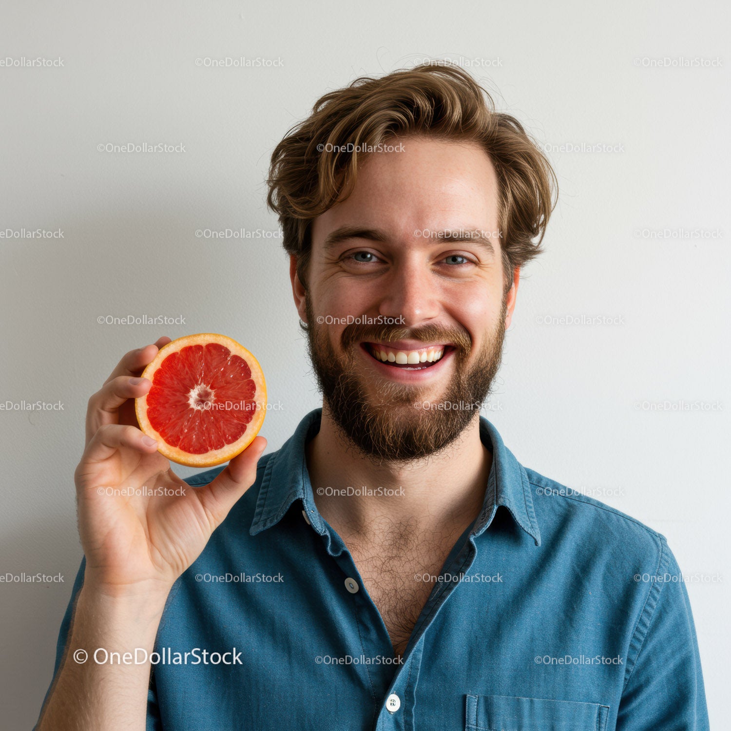 Smiling Man Holding Fresh Grapefruit Slice Close-up Portrait