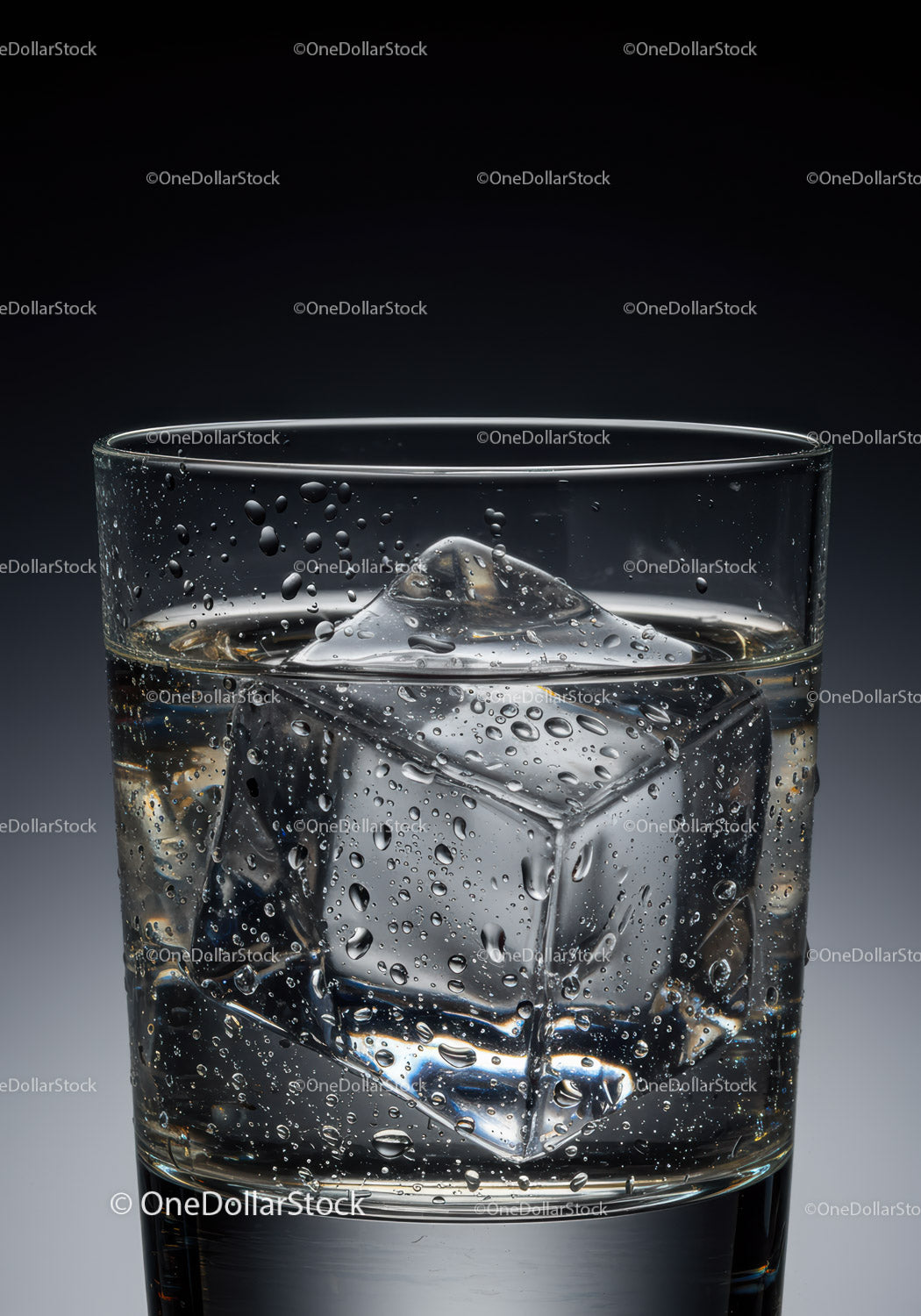 Close up of glass with clear ice cubes and water droplets
