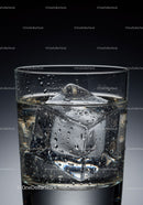 Close up of glass with clear ice cubes and water droplets