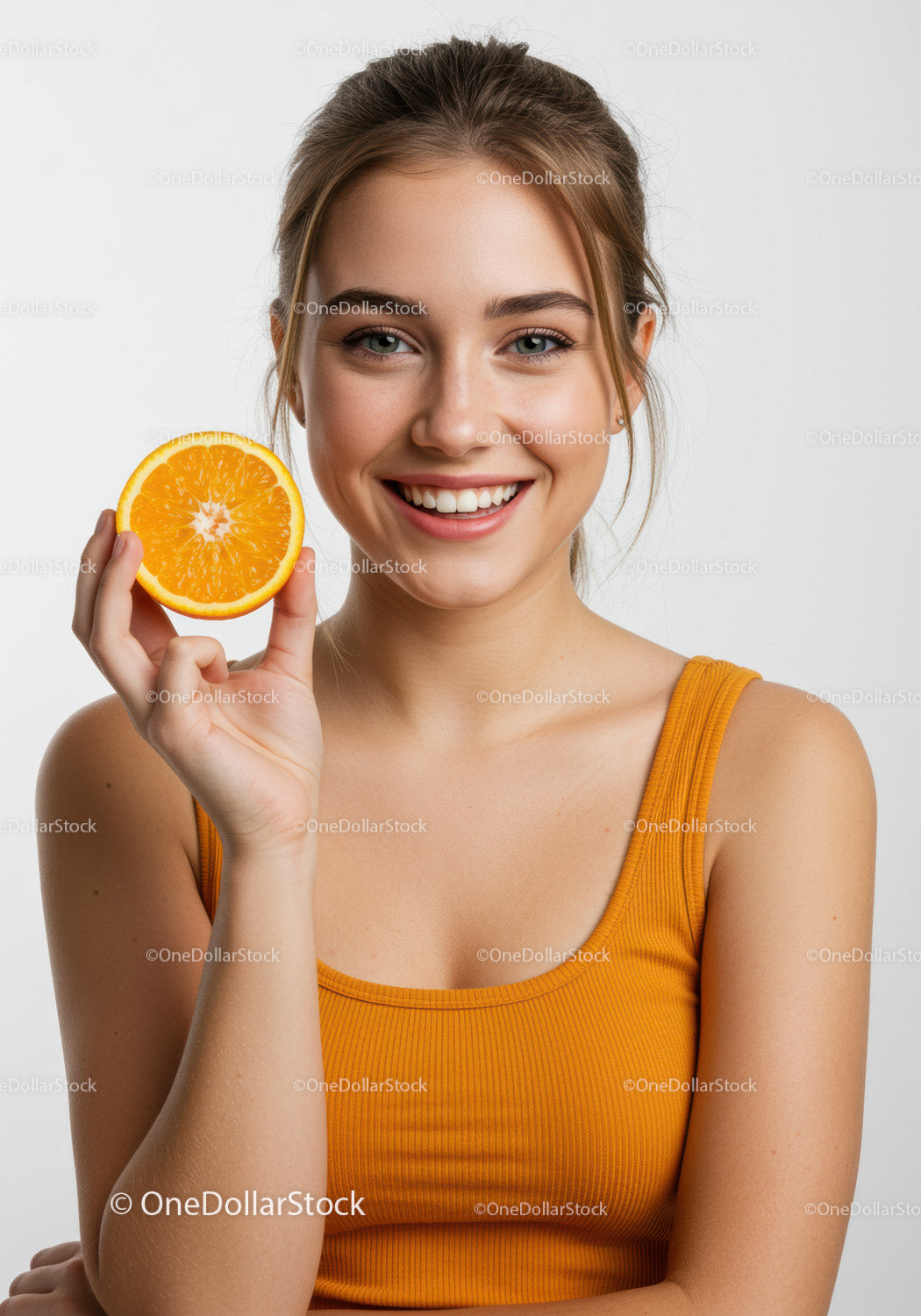 Smiling Young Woman Holding Fresh Orange Slice for Healthy Lifestyle