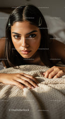 Close-up of Young Woman with Brown Eyes and Hair Clips Lying on Blanket