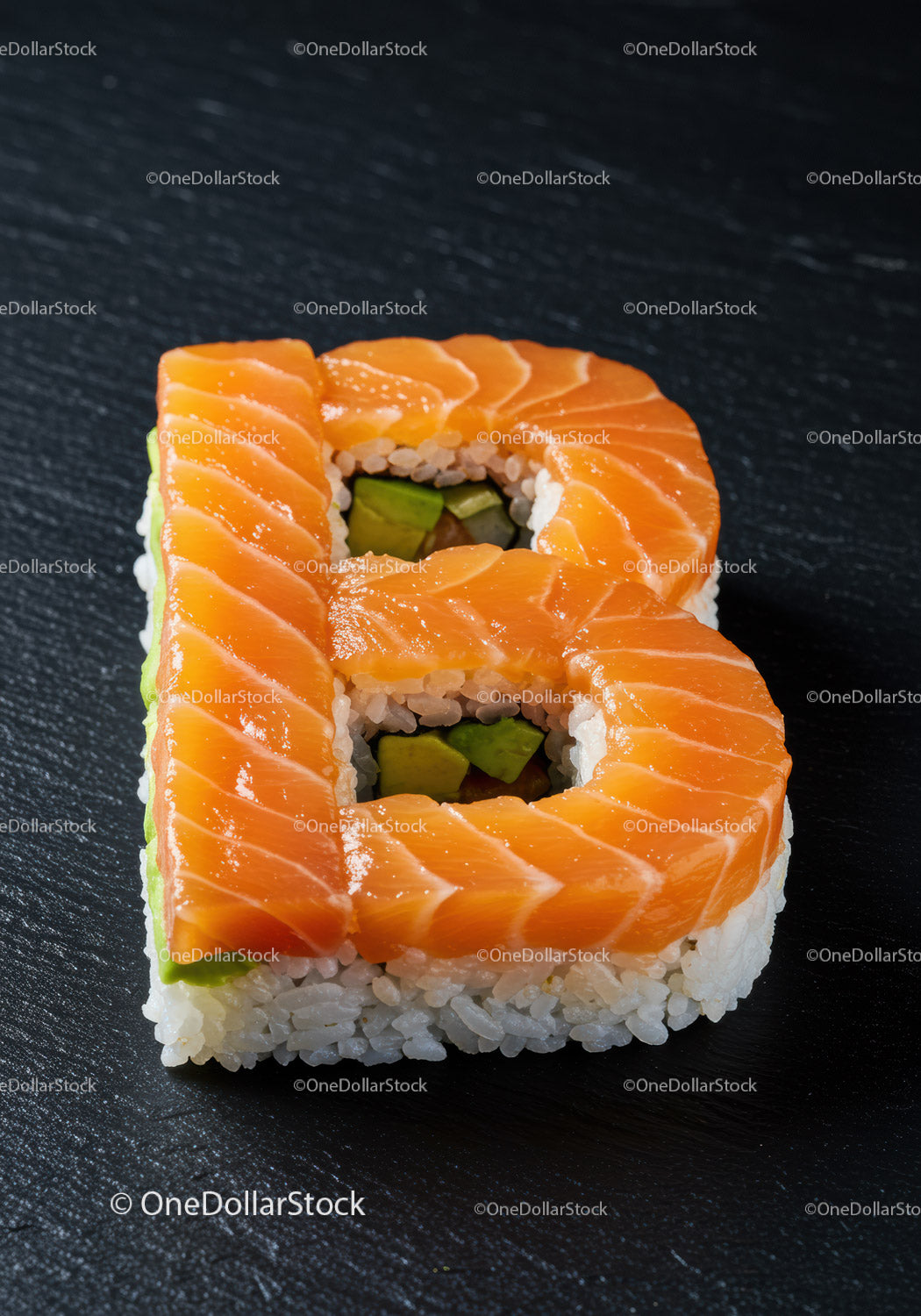 Salmon Sushi Roll Shaped as Letter B on Black Slate