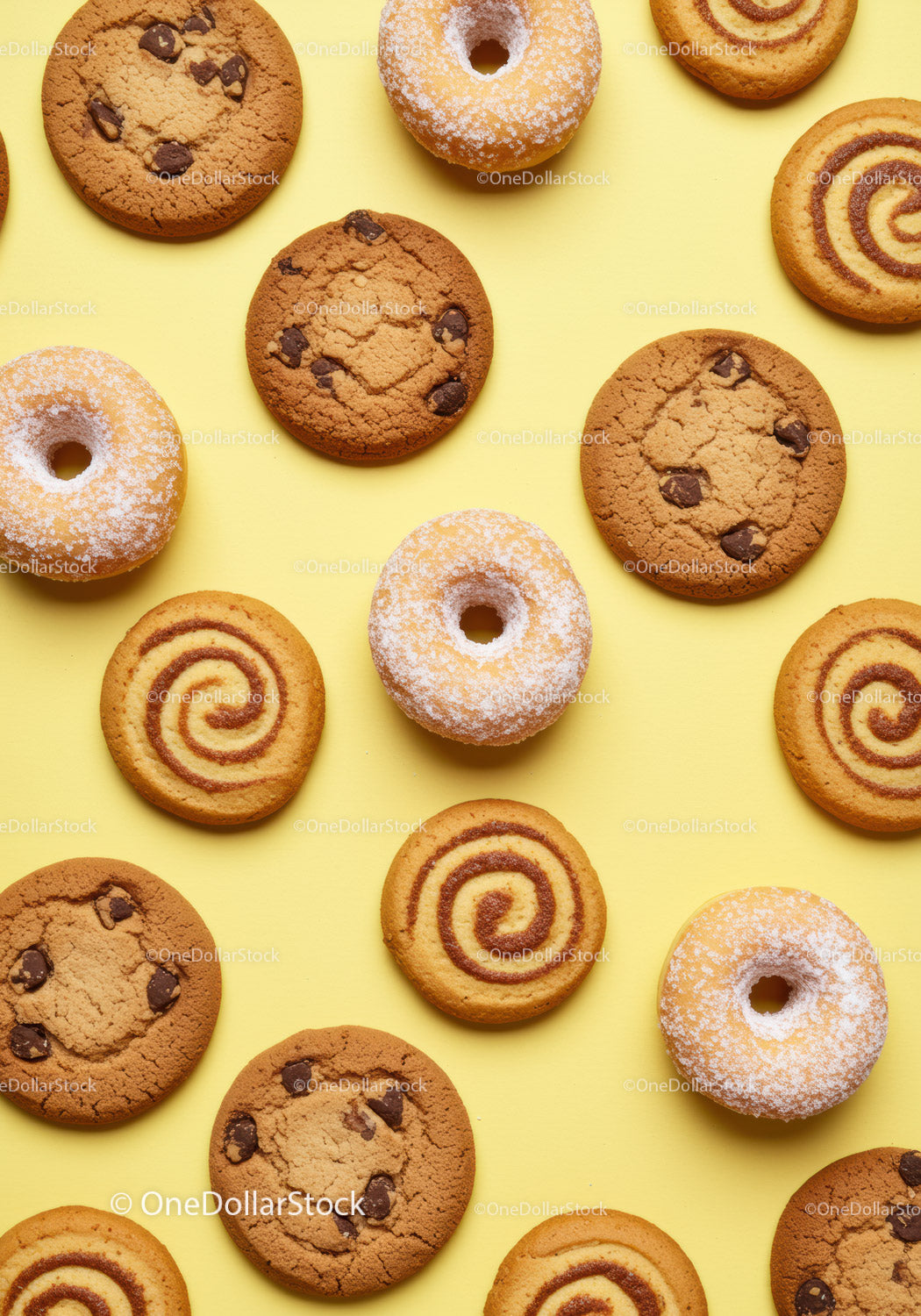 Assorted cookies and powdered donuts on yellow background