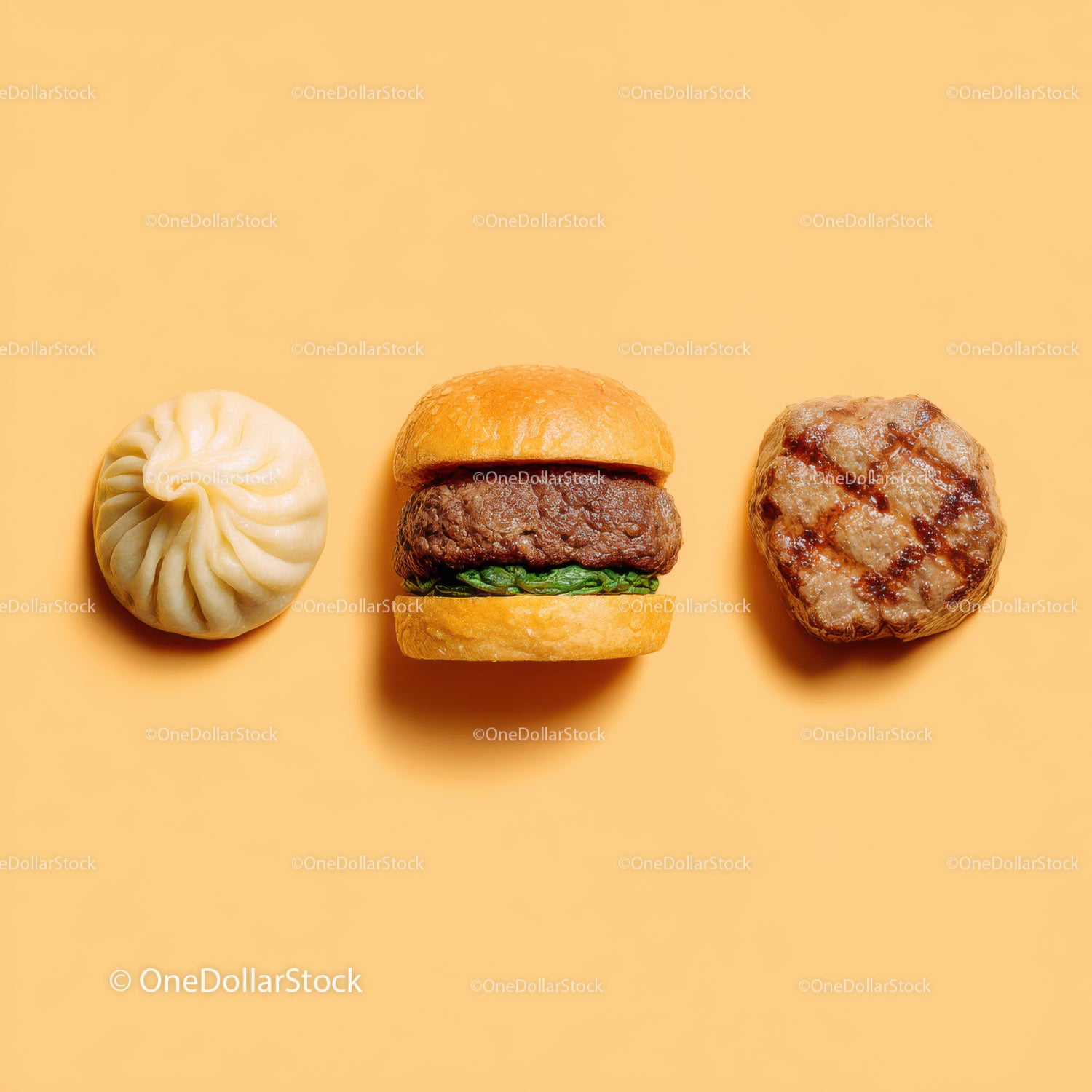 Gourmet Burger with Lettuce and Tomato Next to Grilled Steak and Dumpling