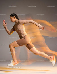 Athletic woman sprinting with motion blur effect