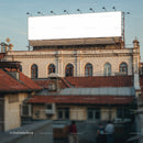 Blank billboard above historic rooftop urban architecture
