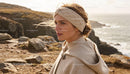 Woman in Cozy Beige Headband by Rocky Sea Coast
