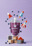 Purple blueberry smoothie with playful rocket toys and blocks