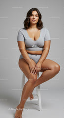 Young Woman Sitting on a White Stool in Casual Clothing for Fashion Photography
