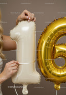 Woman Preparing Cream and Gold Number Balloons