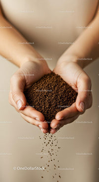 Close up of hands holding pouring coffee granules