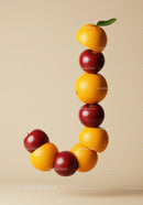 Curved Arrangement of Red Apples and Orange Slices with Leaf