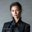 Elegant Woman in Black Suit with Statement Earrings Portrait