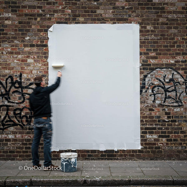 Man Painting Over Graffiti on Urban Brick Wall JPG Mockup Image