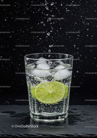 Refreshing sparkling water with lime and ice cubes